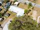 Expansive aerial view of the property showcasing the unique metal roof, spacious yard, and convenient outbuildings at 3823 N 56Th St, Tampa, FL 33619