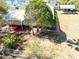 Elevated view showing a well-kept home featuring a red walkway, a fence, and lush landscaping at 3823 N 56Th St, Tampa, FL 33619