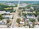 An aerial view showcases this charming property in a neighborhood with nearby commercial area, trees and a distant lake at 3823 N 56Th St, Tampa, FL 33619