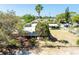 Aerial view capturing the property featuring a mature palm tree, a well-kept lawn, and a surrounding fence at 3823 N 56Th St, Tampa, FL 33619