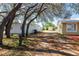Backyard featuring mature trees and a large storage shed at 3823 N 56Th St, Tampa, FL 33619