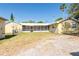 View of the back of the home with a fenced-in yard and a screened-in porch at 3823 N 56Th St, Tampa, FL 33619