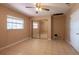 Bedroom featuring tiled floors, a sliding mirror closet, a ceiling fan, and ample natural light at 3823 N 56Th St, Tampa, FL 33619