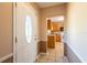 Entryway showcasing a decorative glass door leading into a hallway with a view of the kitchen at 3823 N 56Th St, Tampa, FL 33619