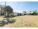 Inviting exterior of a single-story home with mature landscaping and a metal carport at 3823 N 56Th St, Tampa, FL 33619
