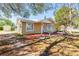 View of a charming single-story home featuring a well-maintained yard at 3823 N 56Th St, Tampa, FL 33619