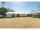 Charming single-story home with white door, mature landscaping, and metal carport at 3823 N 56Th St, Tampa, FL 33619
