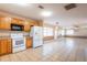 Bright kitchen with white appliances, wood cabinets, and tile flooring at 3823 N 56Th St, Tampa, FL 33619