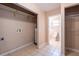 Laundry room with utility sink, storage, and tile flooring at 3823 N 56Th St, Tampa, FL 33619
