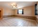 Living room showcasing tile flooring and a window with dark curtains at 3823 N 56Th St, Tampa, FL 33619