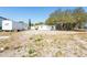 Large lot with several outbuildings and a mix of grass and gravel at 3823 N 56Th St, Tampa, FL 33619
