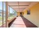Long screened porch with painted concrete flooring at 3823 N 56Th St, Tampa, FL 33619