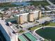 Aerial view of multi-story condo buildings, parking, and lake at 4725 Cove Cir # 601, St Petersburg, FL 33708