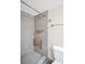 Bathroom with accessible shower featuring grey tiles and a folding seat at 4725 Cove Cir # 601, St Petersburg, FL 33708