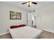 Neutral bedroom with ceiling fan, wood flooring, and view to adjacent hallway at 4725 Cove Cir # 601, St Petersburg, FL 33708