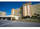 Low angle view of the Columbia building showcasing its facade and parking at 4725 Cove Cir # 601, St Petersburg, FL 33708