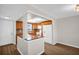 Open kitchen featuring wood cabinets, granite counters, a breakfast bar, and a skylight at 4725 Cove Cir # 601, St Petersburg, FL 33708