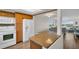 Bright kitchen with granite countertop island, white appliances, and wooden cabinets at 4725 Cove Cir # 601, St Petersburg, FL 33708
