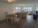 Open-concept living area with dining table and chairs, comfortable seating, and water views at 4725 Cove Cir # 601, St Petersburg, FL 33708