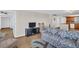 Cozy living room with a comfortable sofa, entertainment center, and view into the kitchen at 4725 Cove Cir # 601, St Petersburg, FL 33708