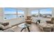 Bright living room featuring large windows with stunning water views and comfortable seating at 4725 Cove Cir # 601, St Petersburg, FL 33708