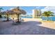 Outdoor patio with tiki hut and seating; building in the background at 4725 Cove Cir # 601, St Petersburg, FL 33708
