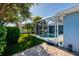 Serene backyard featuring a screened-in pool, patio, and lush landscaping at 4997 W Breeze Cir, Palm Harbor, FL 34683