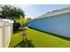 Manicured backyard with artificial turf and an accent tree at 4997 W Breeze Cir, Palm Harbor, FL 34683
