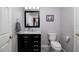 Modern bathroom with black vanity and neutral wall color at 4997 W Breeze Cir, Palm Harbor, FL 34683