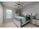 Bright bedroom with ceiling fan, neutral walls, carpet, and a window for natural light at 4997 W Breeze Cir, Palm Harbor, FL 34683