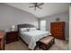 Comfortable bedroom with plush carpeting, ceiling fan, and wood furniture at 4997 W Breeze Cir, Palm Harbor, FL 34683
