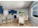 Dining room features a wooden table, six chairs, and a window with natural light at 4997 W Breeze Cir, Palm Harbor, FL 34683