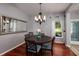 Cozy dining room featuring hardwood floors, a round table with seating for four, and a stylish light fixture at 4997 W Breeze Cir, Palm Harbor, FL 34683