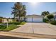 Charming single-story home with well-maintained landscaping, a spacious driveway, and a two-car garage at 4997 W Breeze Cir, Palm Harbor, FL 34683