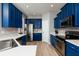 Well-equipped kitchen featuring blue cabinets, stainless steel appliances, and plenty of storage space at 4997 W Breeze Cir, Palm Harbor, FL 34683