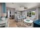 Bright and airy living room with wood floors, comfortable seating, and a large window overlooking the backyard at 4997 W Breeze Cir, Palm Harbor, FL 34683