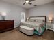 Main bedroom with a colorful bed, hardwood floors, and natural light at 4997 W Breeze Cir, Palm Harbor, FL 34683