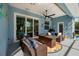Cozy outdoor seating area with ceiling fan and pool view at 4997 W Breeze Cir, Palm Harbor, FL 34683