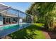 Enclosed pool with artificial turf and outdoor seating at 4997 W Breeze Cir, Palm Harbor, FL 34683