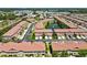 Aerial view of community with mature landscaping, ponds, and nearby shops and restaurants at 5276 6Th N Way, St Petersburg, FL 33703
