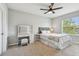 Bright bedroom featuring a vanity and ample natural light from the large windows and a ceiling fan at 5276 6Th N Way, St Petersburg, FL 33703