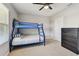 Neutral-toned bedroom with a bunk bed, ceiling fan, plush carpet, and a large window at 5276 6Th N Way, St Petersburg, FL 33703