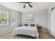 Bright bedroom with neutral walls, carpeted floors, and two windows with blind coverage at 5276 6Th N Way, St Petersburg, FL 33703