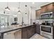 Modern kitchen featuring stainless steel appliances, granite countertops, and stylish pendant lighting at 5276 6Th N Way, St Petersburg, FL 33703