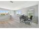 Bright upstairs home office space with a desk, chair, and large windows overlooking the outdoors at 5276 6Th N Way, St Petersburg, FL 33703