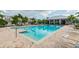 Community pool with a bright blue interior, paved deck, and an open-air pavilion at 5276 6Th N Way, St Petersburg, FL 33703