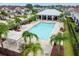 Aerial view of a community pool surrounded by palm trees and lounge chairs, creating a resort-like atmosphere at 5276 6Th N Way, St Petersburg, FL 33703
