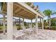 Relaxing poolside featuring lounge chairs under a shaded pergola and a view of the surrounding landscape at 5276 6Th N Way, St Petersburg, FL 33703