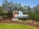 Community signage with landscaping including colorful shrubs, green grass and manicured mulch at 5276 6Th N Way, St Petersburg, FL 33703