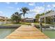 Waterfront home with lush backyard and private dock featuring a boat lift, ideal for boating at 543 Crystal Dr, Madeira Beach, FL 33708